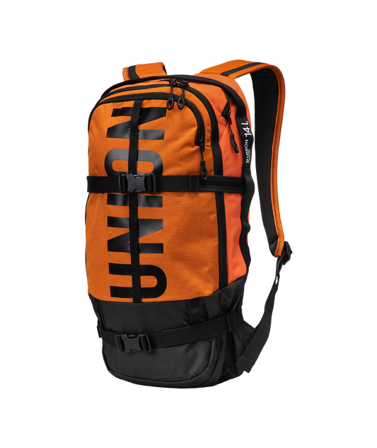 union resort backpack in bright orange with black union writing that goes all the way up the face. black straps go around the body of the bag