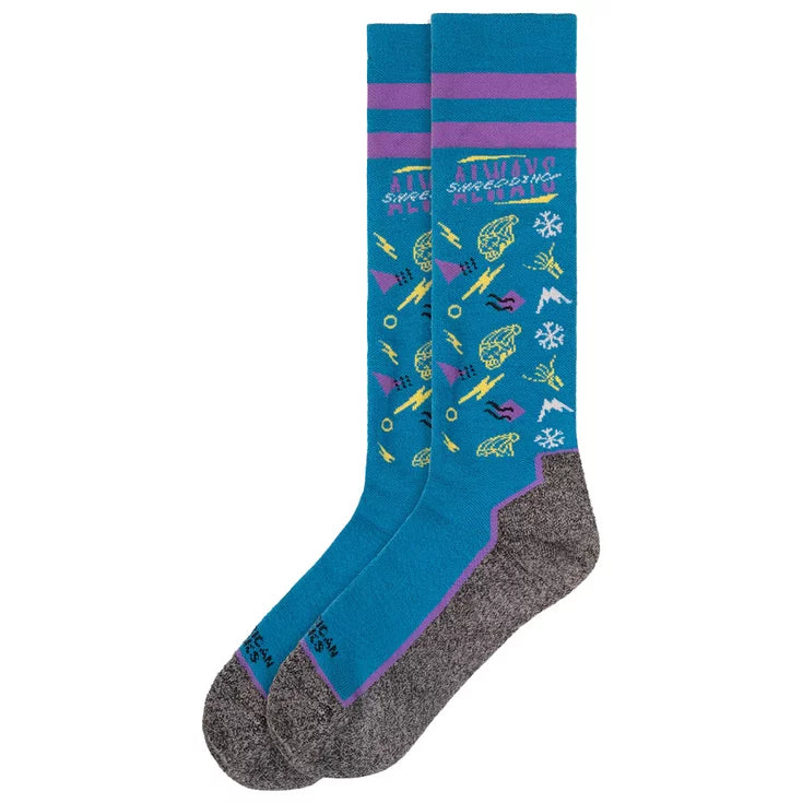 american socks snowboard socks.. blue with grey soles, purple bands around the top. multiple logos in yellow, white and purple with writing that says 'always shredding' at the top