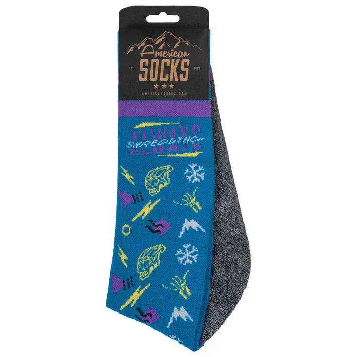 american socks snowboard socks.. blue with grey soles, purple bands around the top. multiple logos in yellow, white and purple with writing that says 'always shredding' at the top