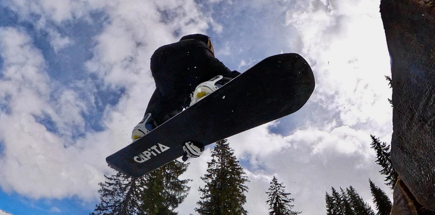 snowboarder in black mid jump