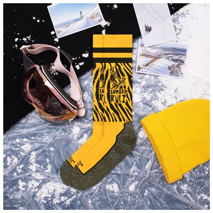 american socks snowboard socks.. yellow with grey soles, black bands around the top.  yellow zebra print and writing that says 'snwbrd rulz' at the top