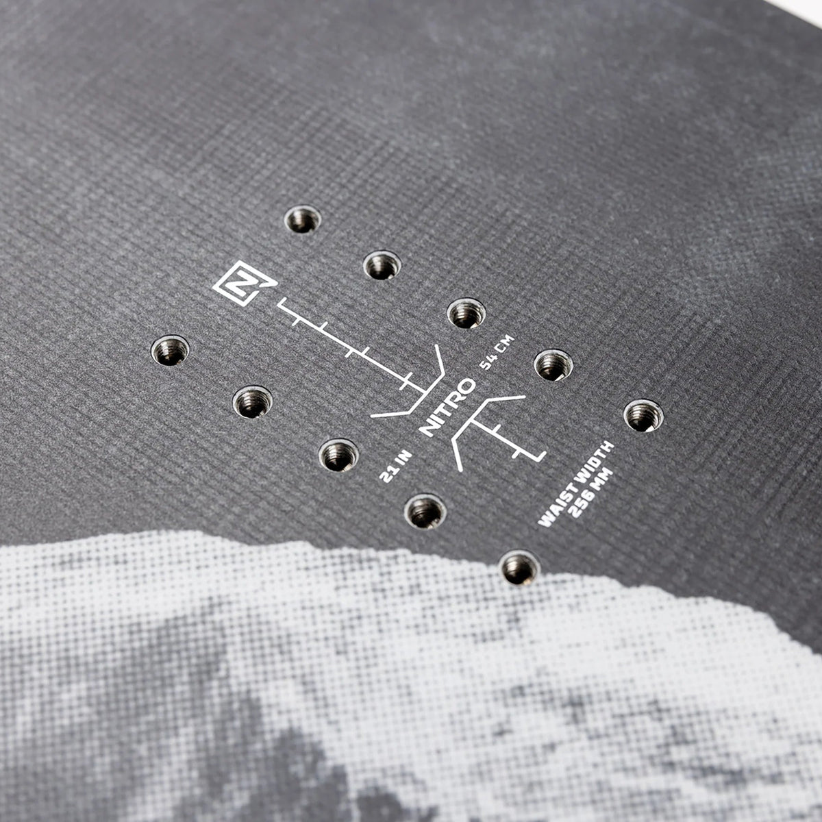 Close-up of a textured surface with a small diagram and text, resembling a moon landing scene.