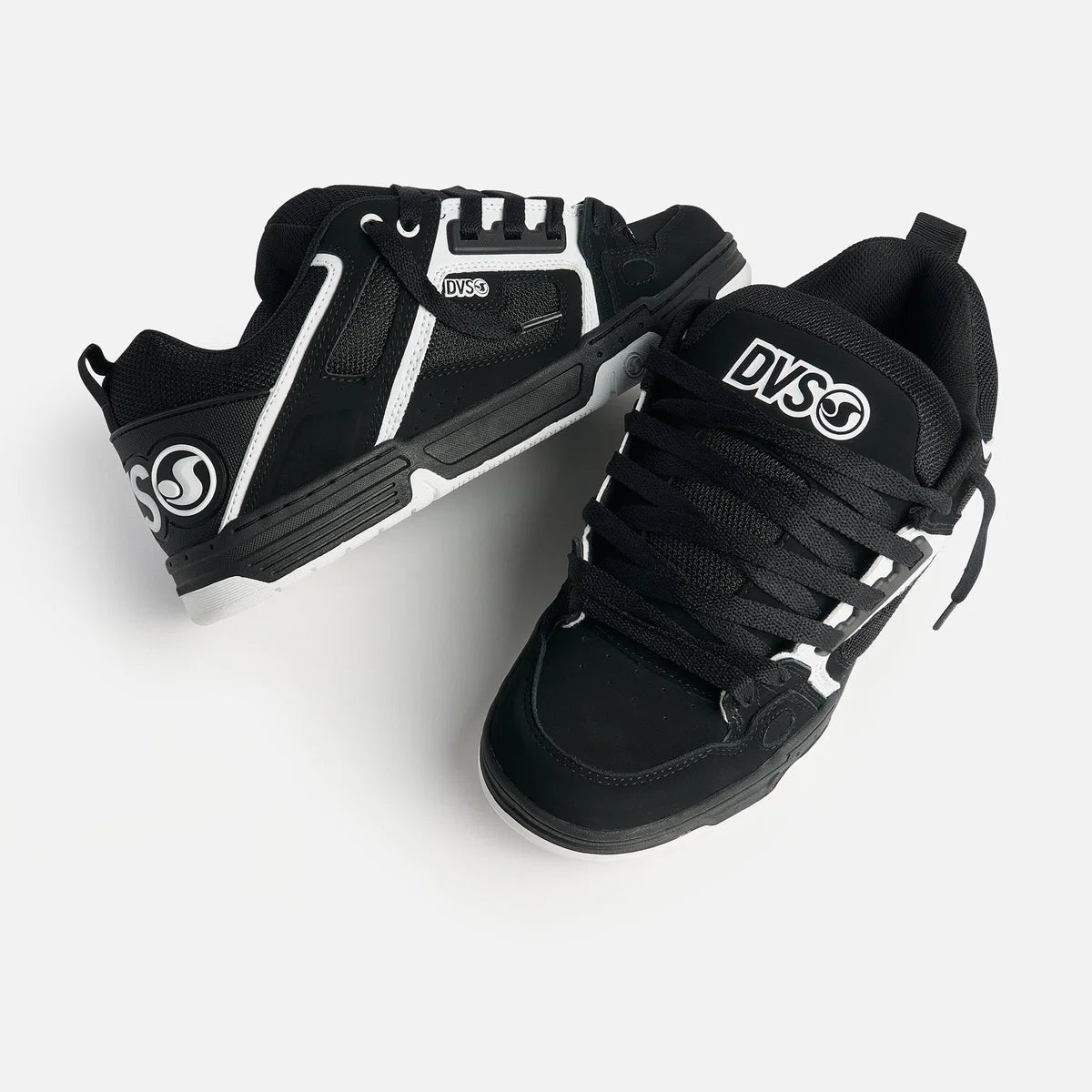 Black sneakers with white accents and DVS logo on a light gray background